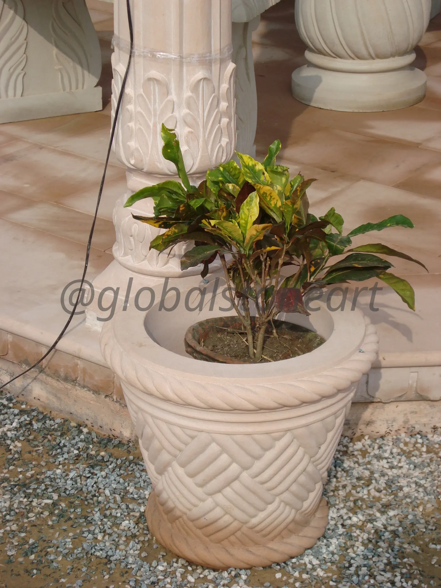 Basket-Weave Carved Sandstone Pot on Marble Patio
