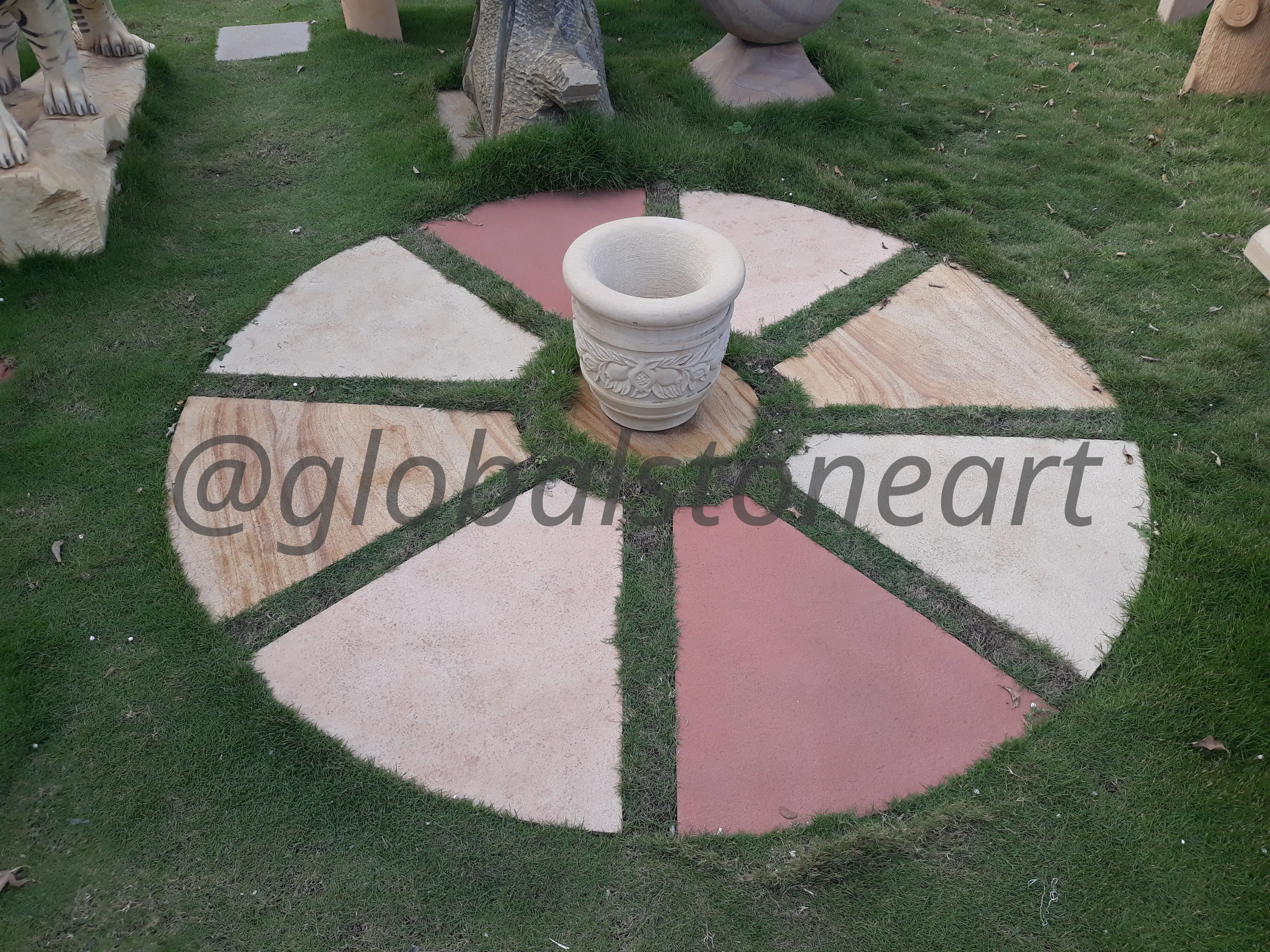 Multicolour Sandstone Wheel Paving Feature with Planter