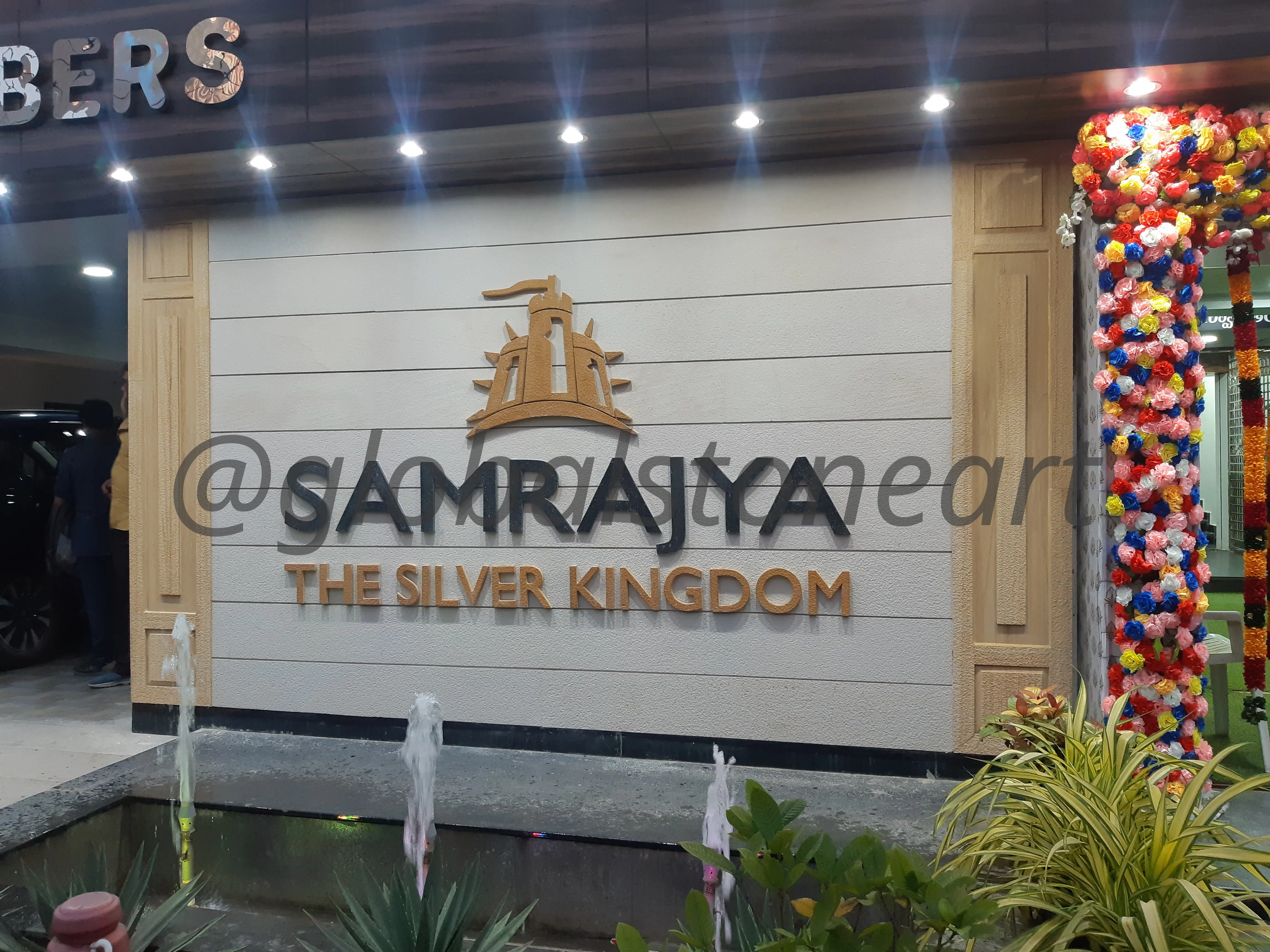 Stone-Clad Wall Signage with 3D Lettering for Commercial Entrance