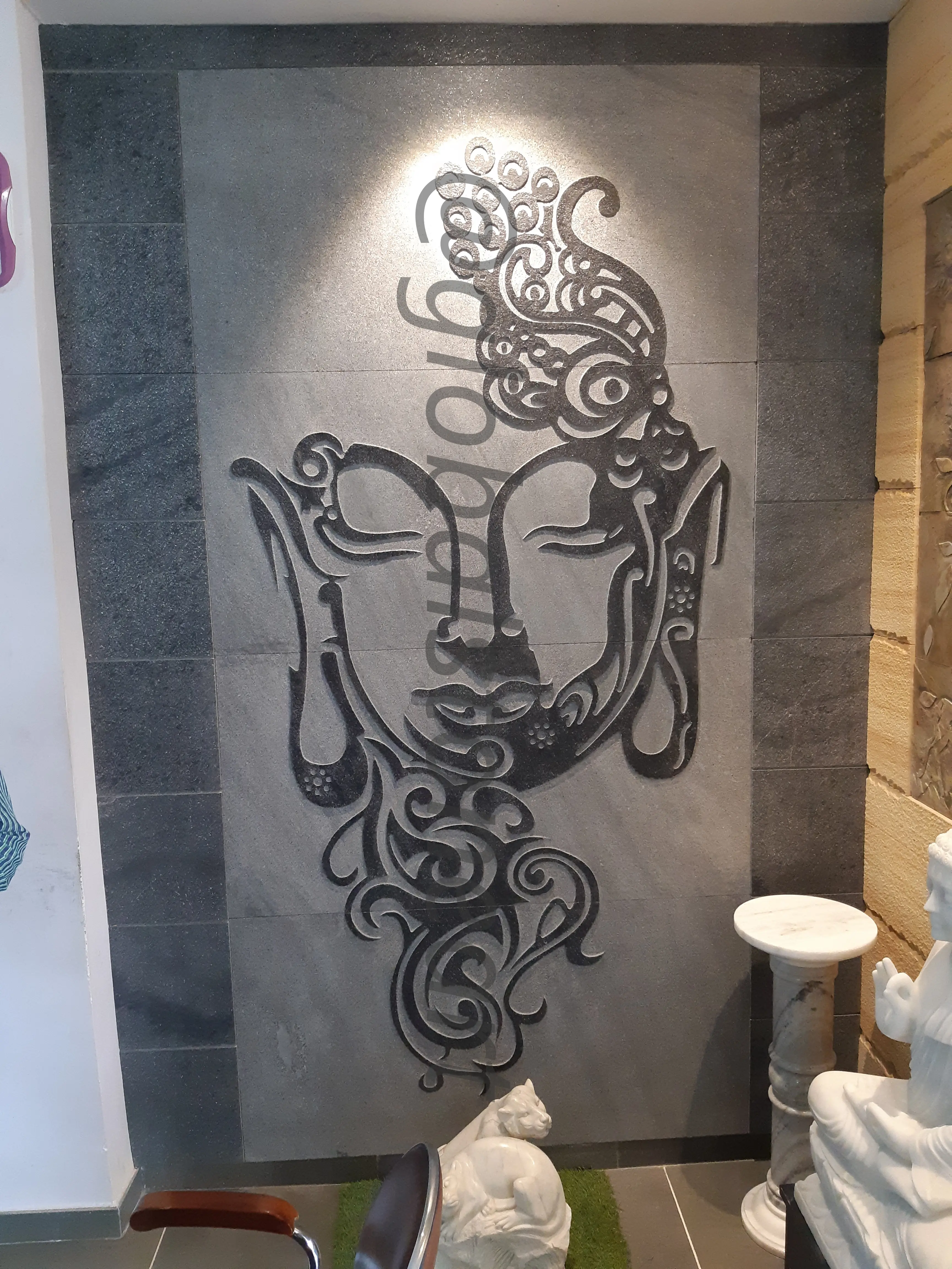 Tribal Buddha Face Stone Mural on Grey Feature Wall