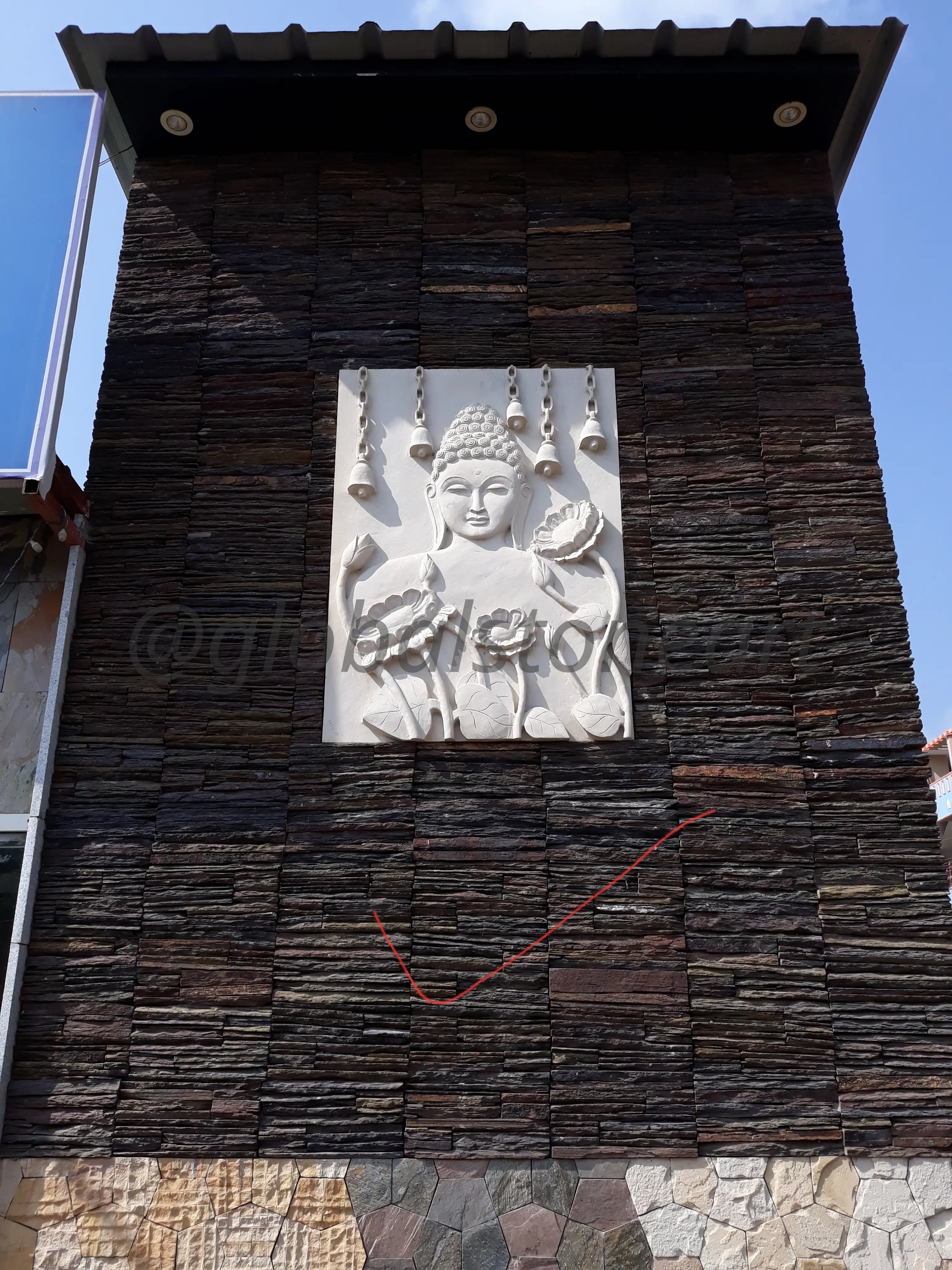 Standing Buddha Sandstone Mural on Stone Facade